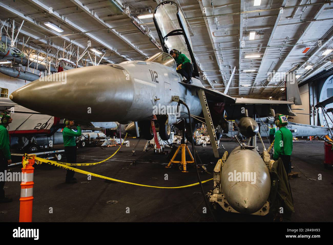 230408-N-PA221-1059 PHILIPPINE SEA, (April 8, 2023). U.S. Navy Sailors perform maintenance on an F/A-18F Super Hornet from the 'Fighting Redcocks' of Strike Fighter Squadron (VFA) 22 landing gear aboard the aircraft carrier USS Nimitz (CVN 68). Nimitz is in U.S. 7th Fleet conducting routine operations. 7th Fleet is the U.S. Navy's largest forward-deployed numbered fleet, and routinely interacts and operates with Allies and partners in preserving a free and open Indo-Pacific region. Stock Photo