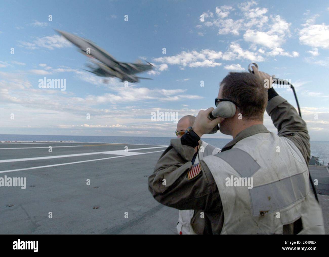 US Navy A Landing Signal Officer (LSO) on the LSO platform guides in an