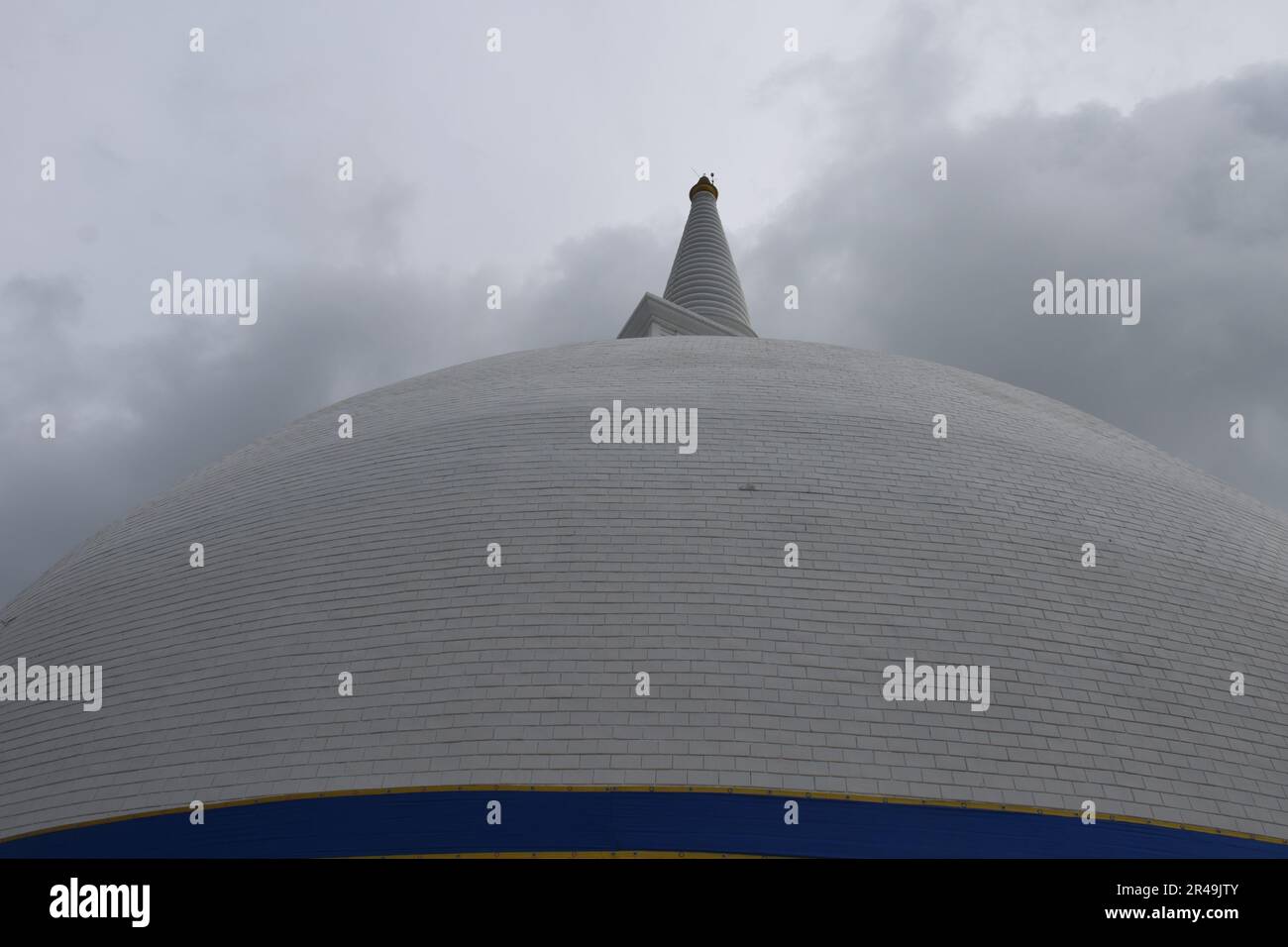 A large white domed building on a cloudy day, with the top of the dome visible Stock Photo