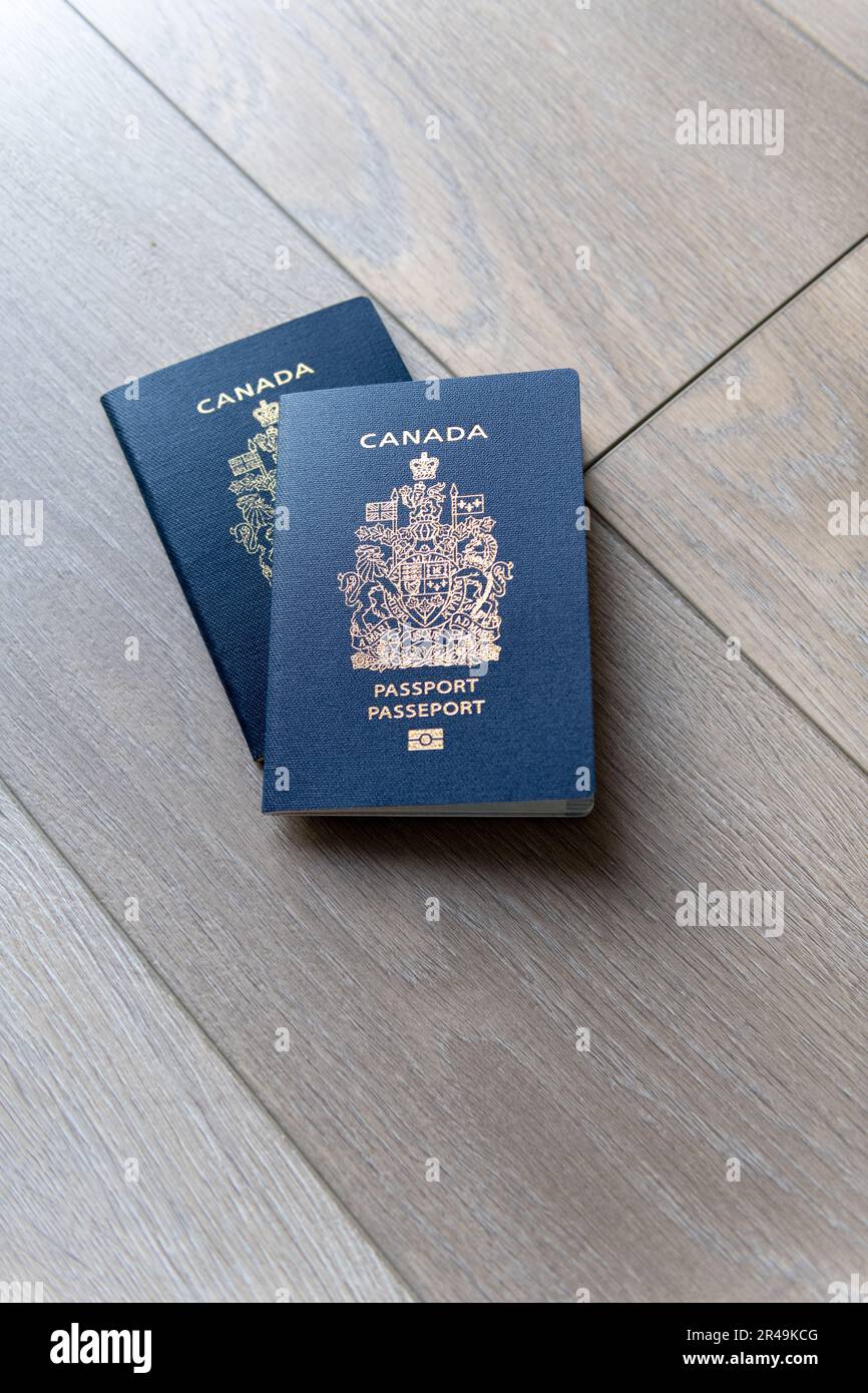 Two Canadian passports on neutral beige background Stock Photo Alamy