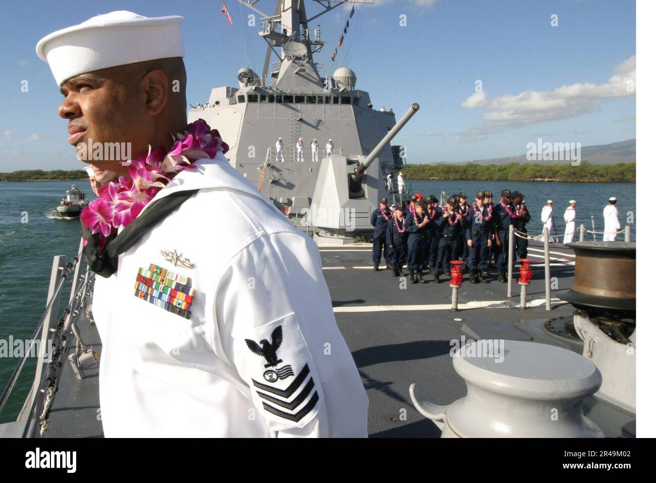 US Navy Sailors man the rails aboard the newly commissioned guided