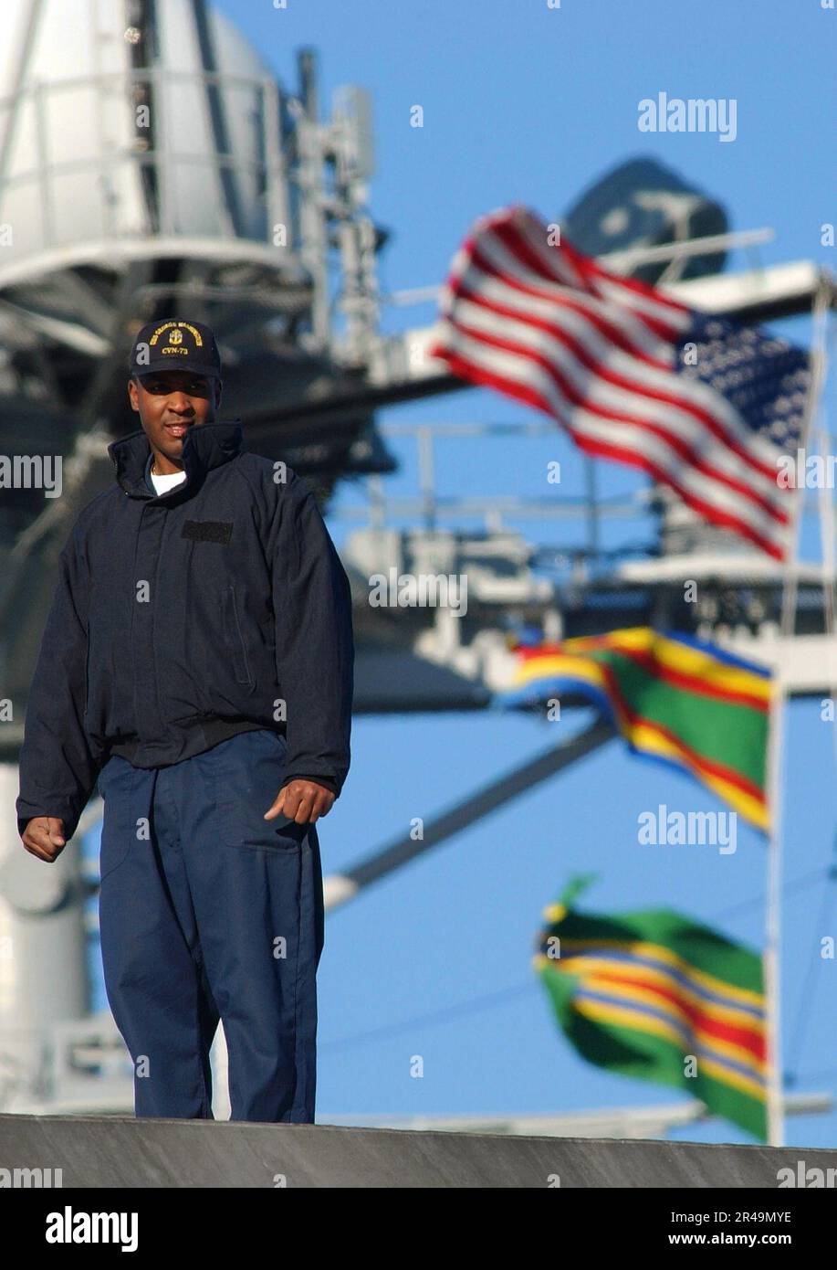 US Navy A sailor stands on the fantail of the USS Washington