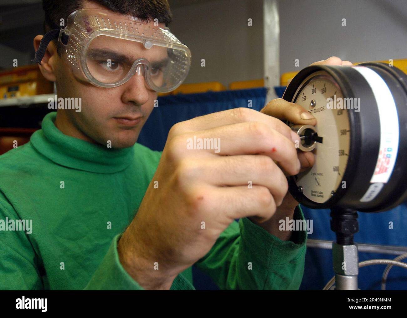 US Navy performs a calibration procedure on a pressure test gauge Stock