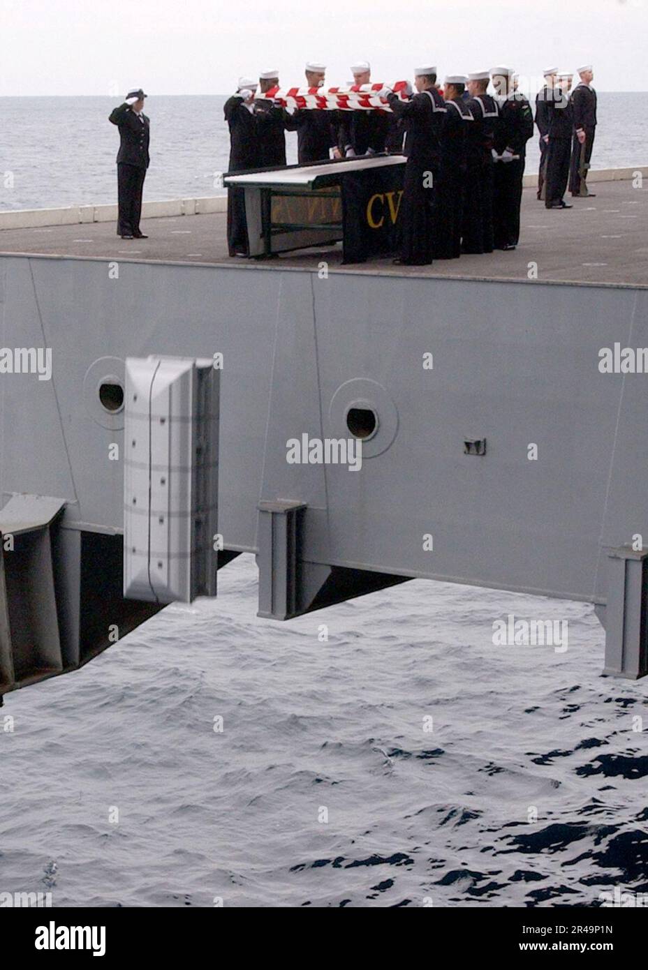 US Navy Pallbearers slowly lift the casket for a retired U.S. Navy ...