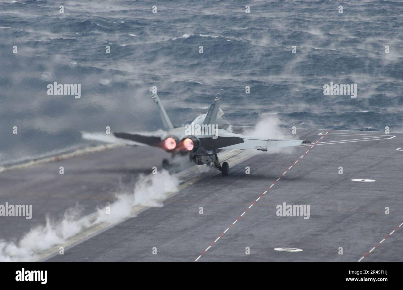 US Navy An F-A-18C Hornet assigned to the ''Golden Warriors'' of Strike Fighter Squadron Eight Seven (VFA-87) completes a catapult launch from flight deck aboard USS Harry S. Truman (CVN 75) Stock Photo