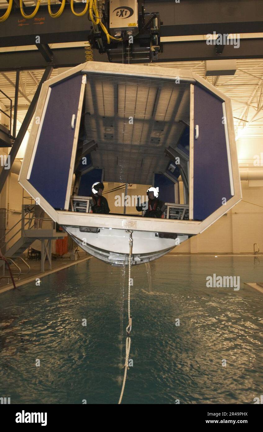 US Navy Instructors assigned to Naval Air Station (NAS) Whidbey Island's Aviation Survival Training Center prepare to demonstrate the Navy's new Modular Egress Training System Stock Photo
