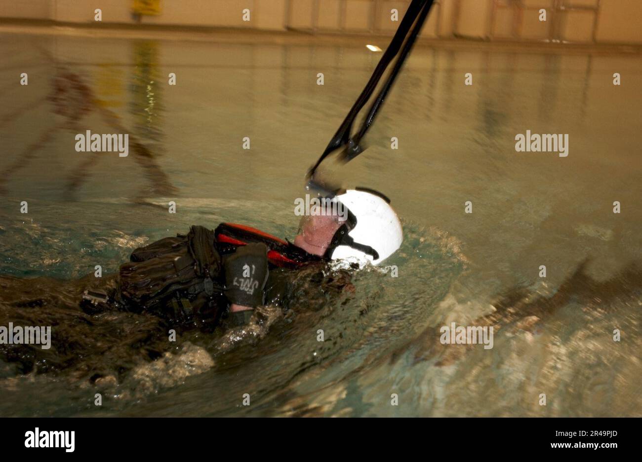 US Navy Instructors assigned to Naval Air Station (NAS) Whidbey Island's Aviation Survival Training Center demonstrate a parachute drag simulation Stock Photo