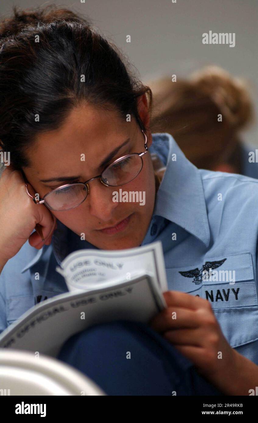 US Navy Sailors assigned to USS Nimitz (CVN 68) concentrate on taking