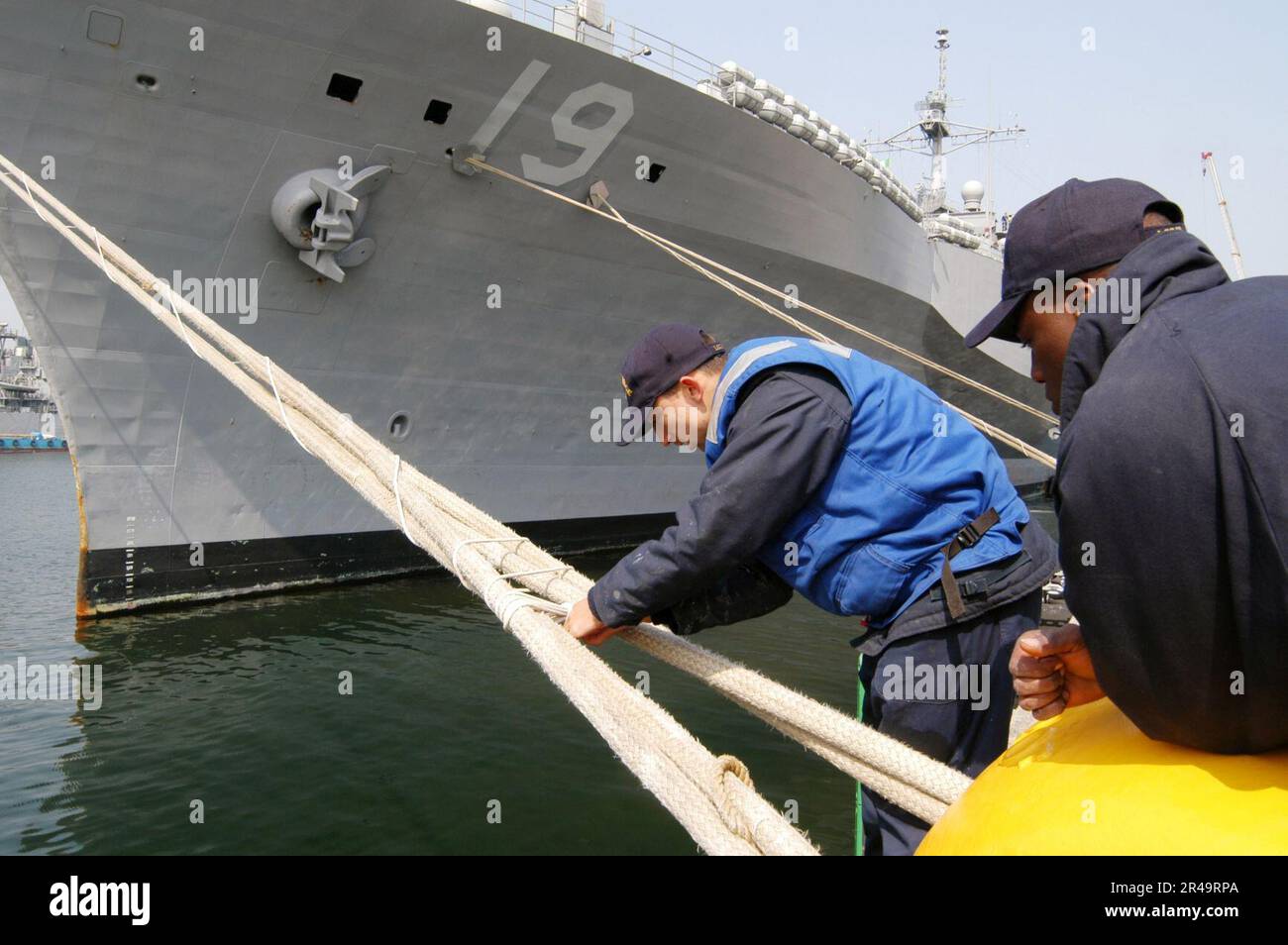 US Navy Under the watchful eye of Boatswain's Mate Seaman tightens the