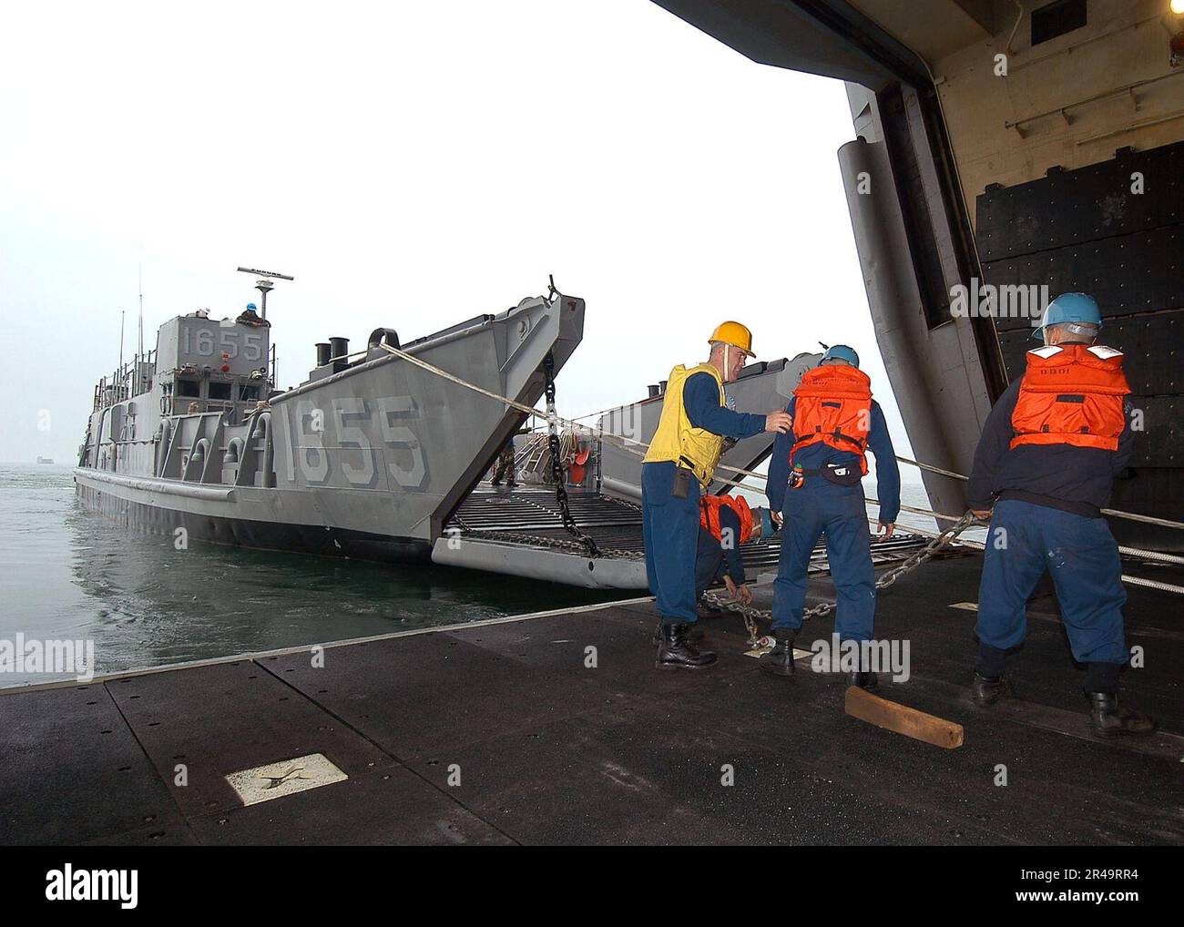 US Navy Boatswain's Mate 1st Class supervises Sailors during the
