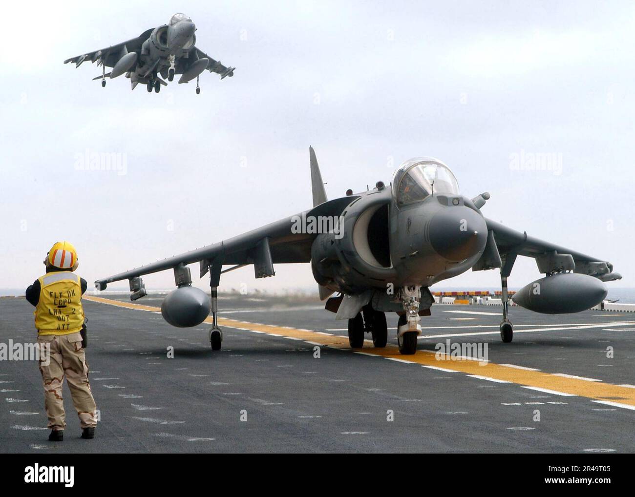 US Navy Chief Aviation Boatswain's Mate watches a AV8B Harrier