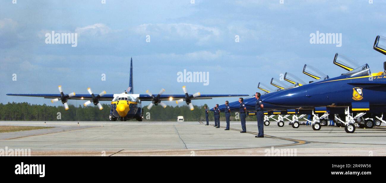 US Navy A specially designed Lockheed C-130 Hercules nicknamed Fat Albert belonging to the U.S. Navy's flight demonstration team Blue Angels, taxis near a row of ready F-A-18C Hornet aircraft Stock Photo