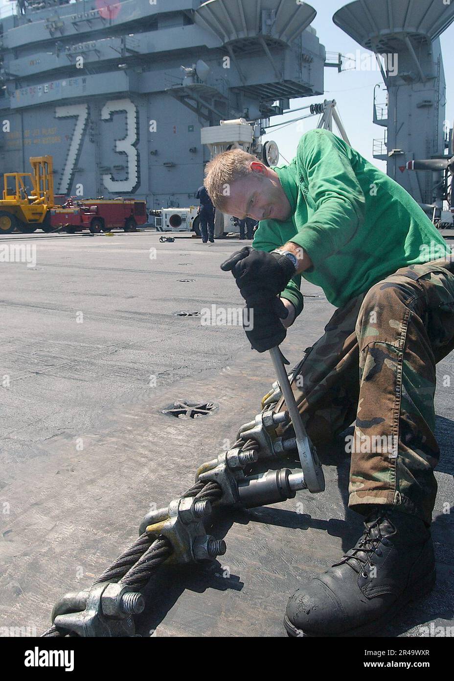 US Navy Aviation Boatswain's Mate Airman Apprentice uses a torque