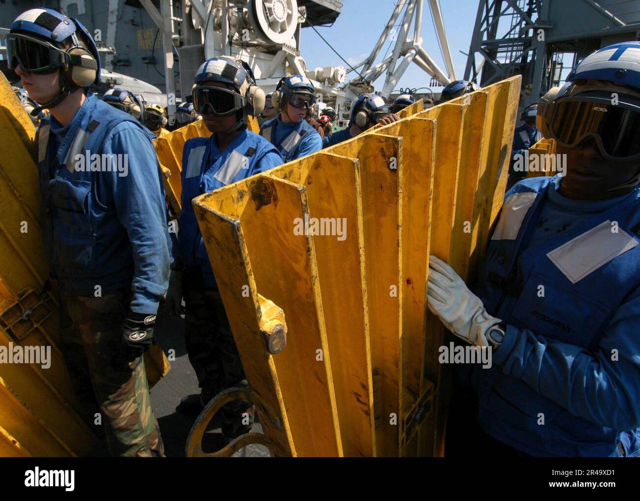 US Navy Air department personnel stand-by with deck ramps for the ...