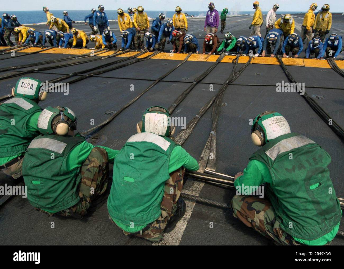 US Navy Air department personnel stretch the emergency barricade ropes ...