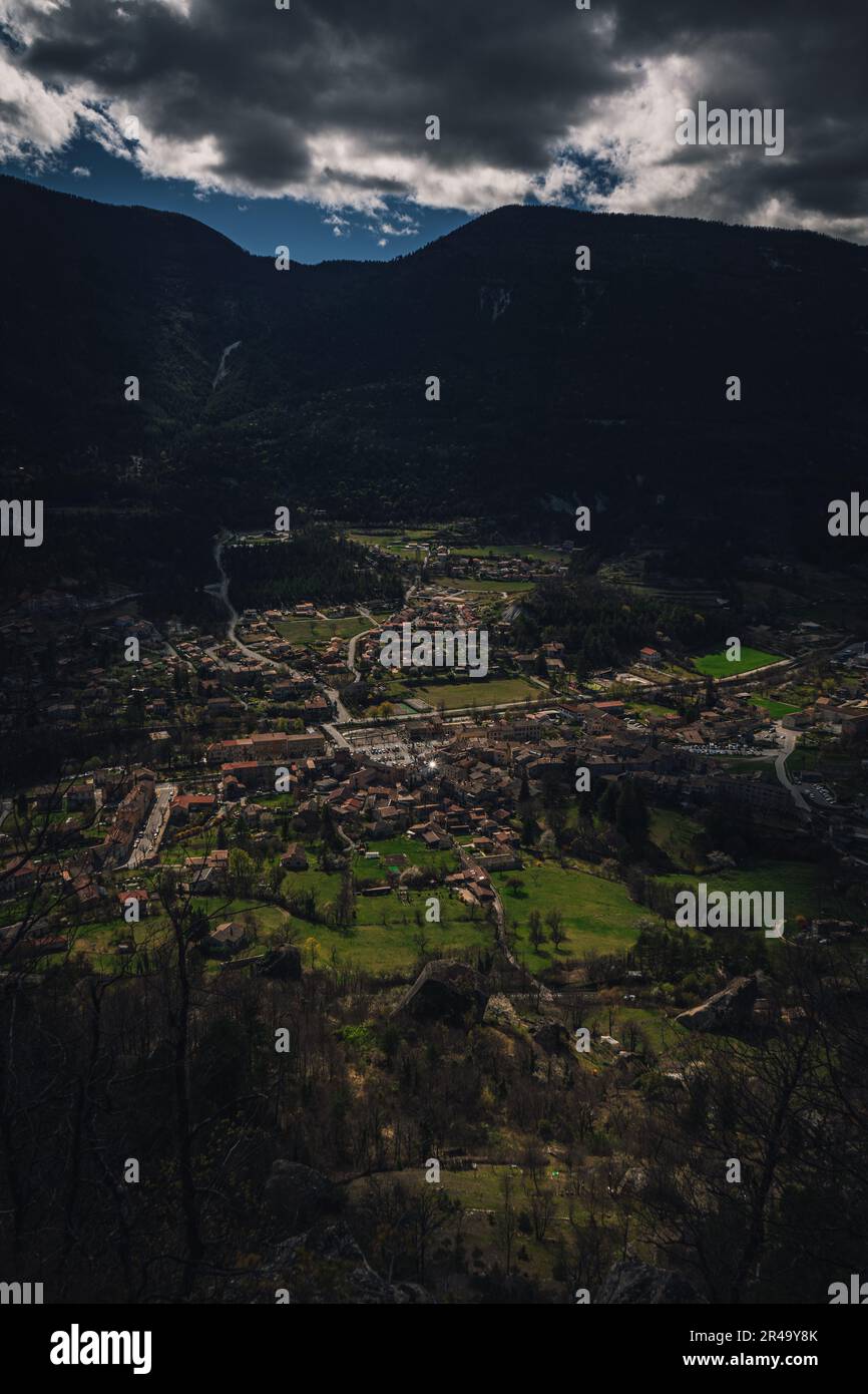 An aerial view of a picturesque mountain town is illuminated by the ...
