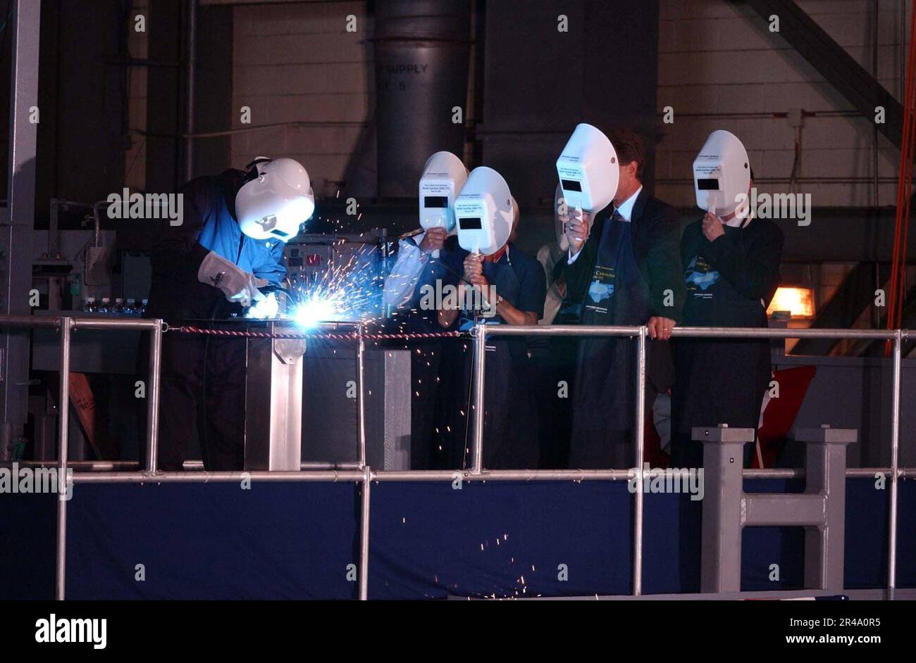 US Navy Welder permanently welds the initials of Ship's Sponsor Mrs ...