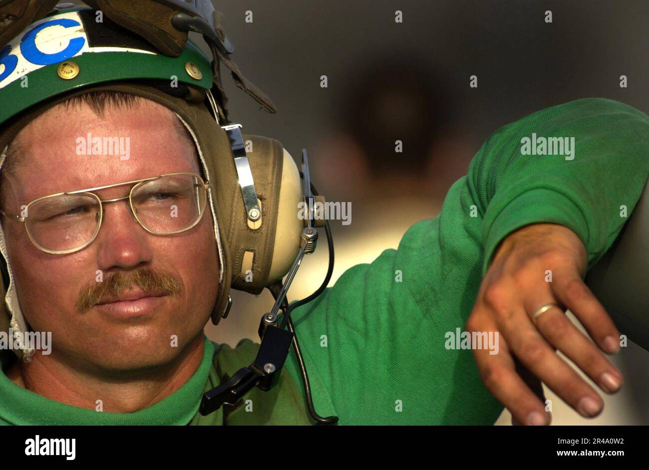 US Navy Chief Aviation Electronics Technician waits near an FA18C