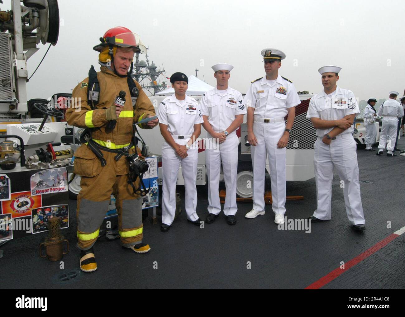 US Navy Steve Doocy of Fox News, demonstrates a U.S. Navy Fire Fighting Ensemble with Damage Controlmen assigned to the amphibious assault ship USS Iwo Jima (LHD 7) Stock Photo