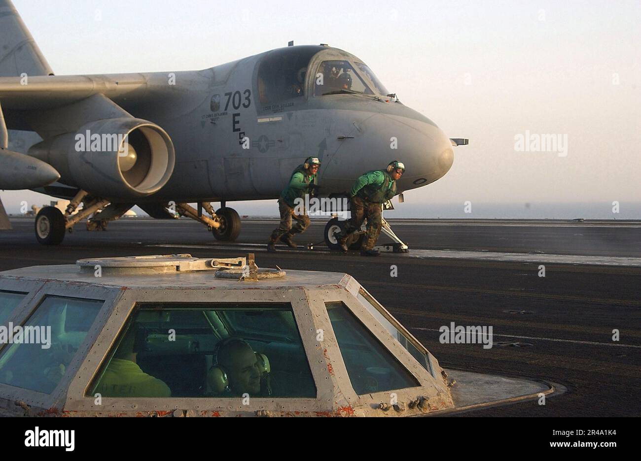 US Navy Air Department crew members position an S-3B Viking assigned to ...