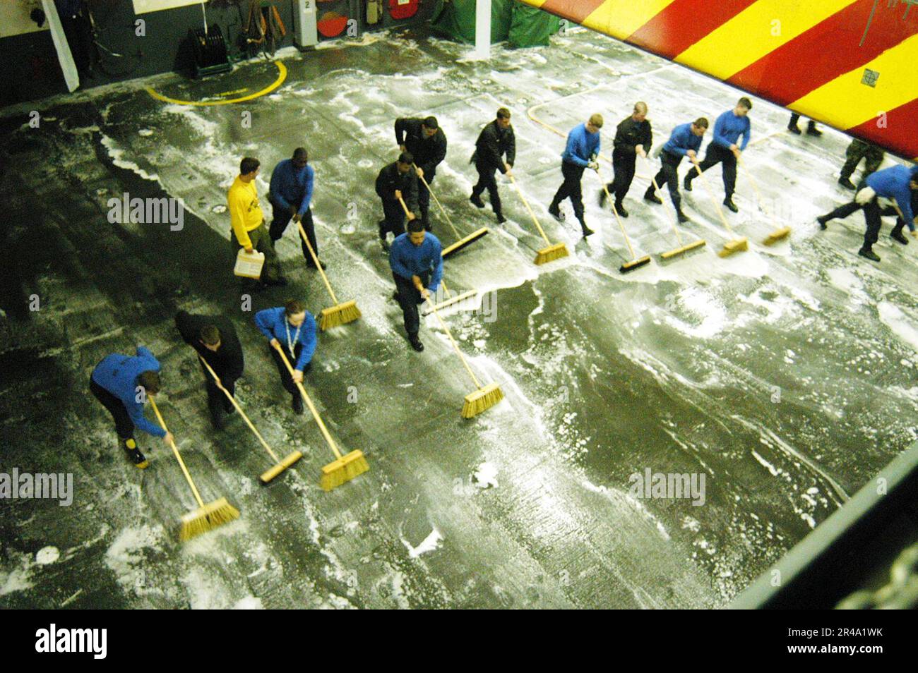 us-navy-uss-abraham-lincoln-cvn-72-sailors-from-air-departments-v-3-division-scrub-down-hangar-bays-one-and-two-after-testing-the-counter-measure-wash-down-system-2R4A1WK.jpg