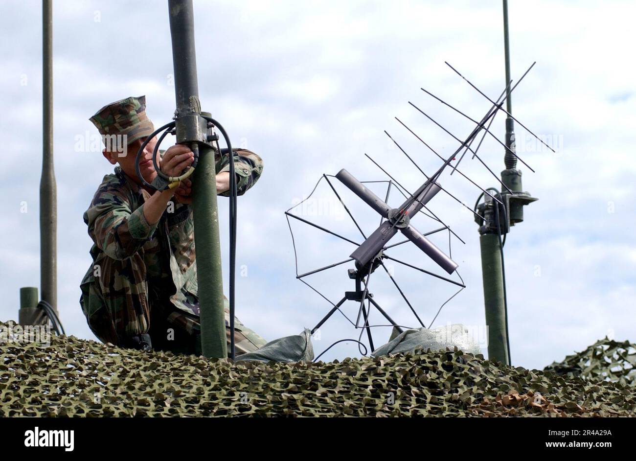 US Navy Ground Aviation Radio Repairman checks the wiring on the VHF AS