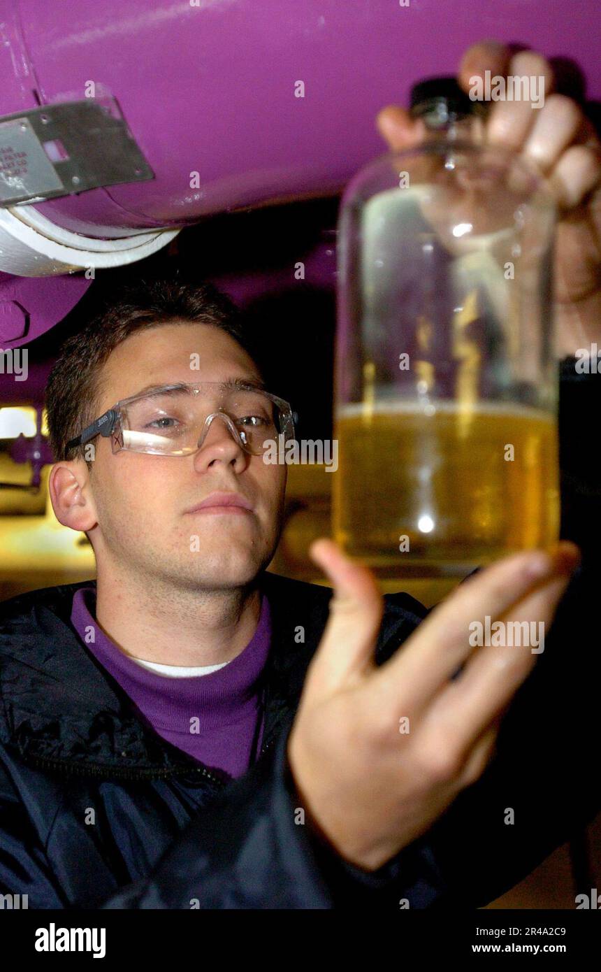 US Navy Airman inspects a sample of JP5 jet fuel Stock Photo Alamy