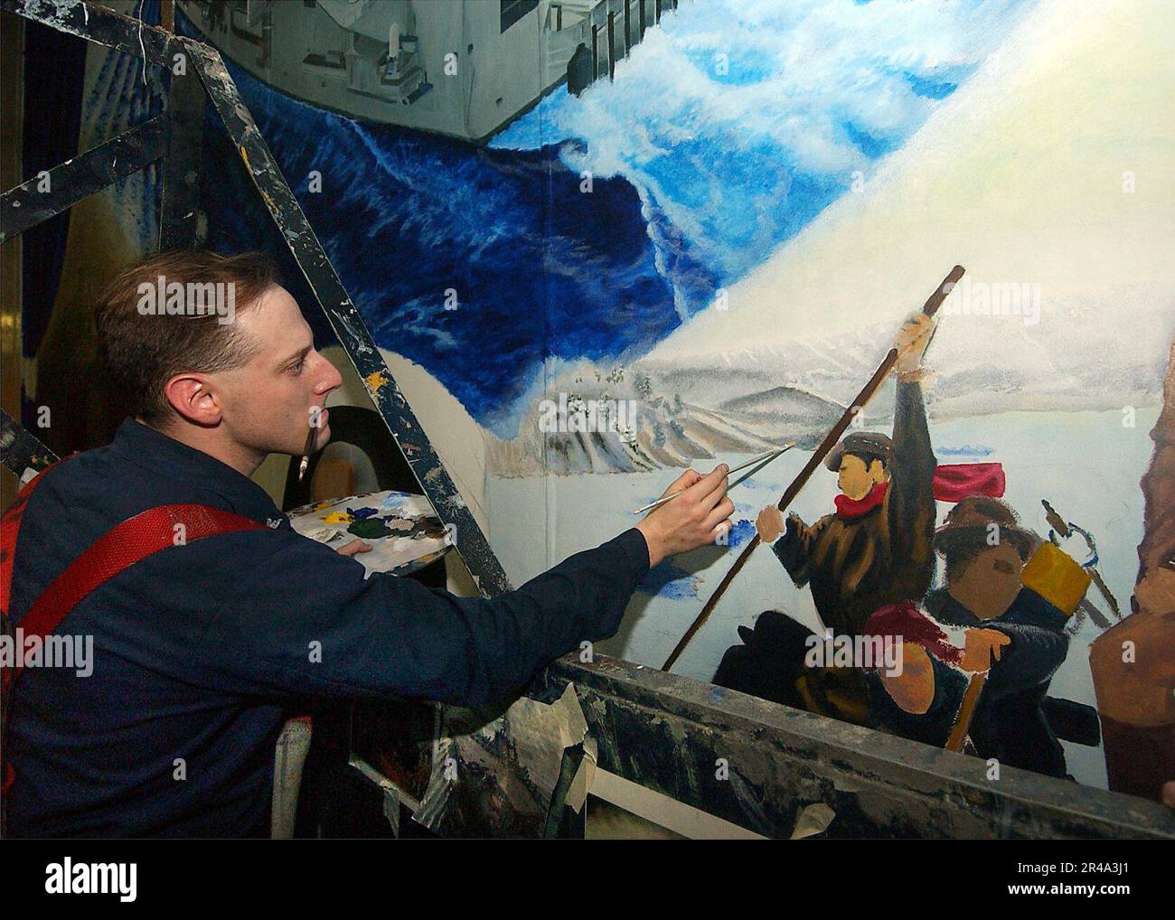 US Navy Aviation Boatswain's Mate 1st Class works from photographs to