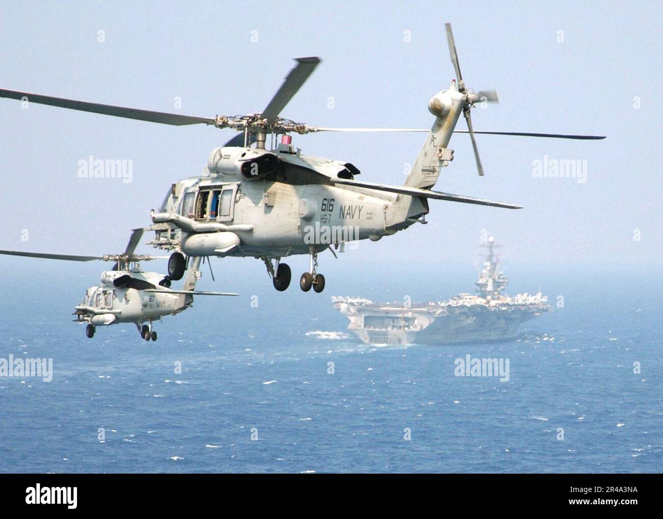 US Navy Two HH-60H Seahawk helicopters assigned to the ''Dusty Dogs'' of Helicopter Anti-Submarine Squadron Seven (HS-7), prepare to land on the flight deck Stock Photo