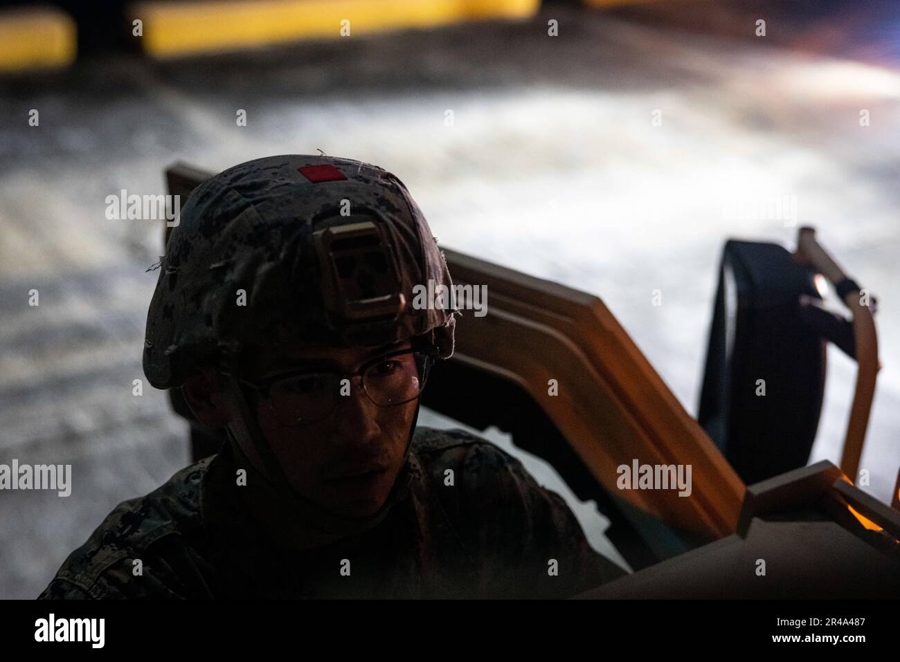 U.S. Marine Corps Lance Cpl. Takenya Yazzie, a motor transport operator with 3rd Landing Support Battalion, checks his Joint Light Tactical Vehicle prior to a convoy during a combined joint logistics over-the-shore offload in preparation for Balikatan 23 at Camp Agnew, Casiguran, Philippines, April 6, 2023. Balikatan is an annual exercise between the Armed Forces of the Philippines and U.S. military designed to strengthen bilateral interoperability, capabilities, trust, and cooperation built over decades shared experiences. Stock Photo