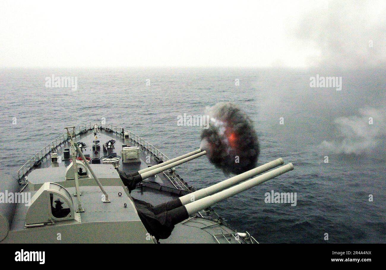 US Navy The Peruvian cruiser Almirante Grau CLM-81 fires one of its 15.2 cm caliber cannons Stock Photo