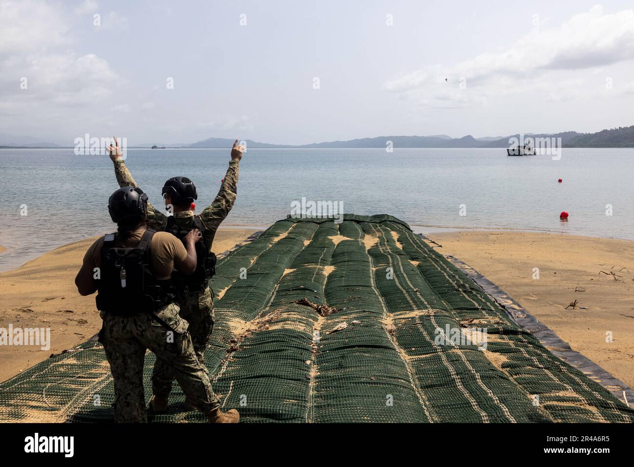 U.S. Navy Sailors with Beachmaster Unit 1 signal an Army Landing Craft Mechanized in preparation for Balikatan 23 at Camp Agnew, Casiguran, Philippines, April 8, 2023. Balikatan is an annual exercise between the Armed Forces of the Philippines and U.S. military designed to strengthen bilateral interoperability, capabilities, trust, and cooperation built over decades shared experiences. Stock Photo