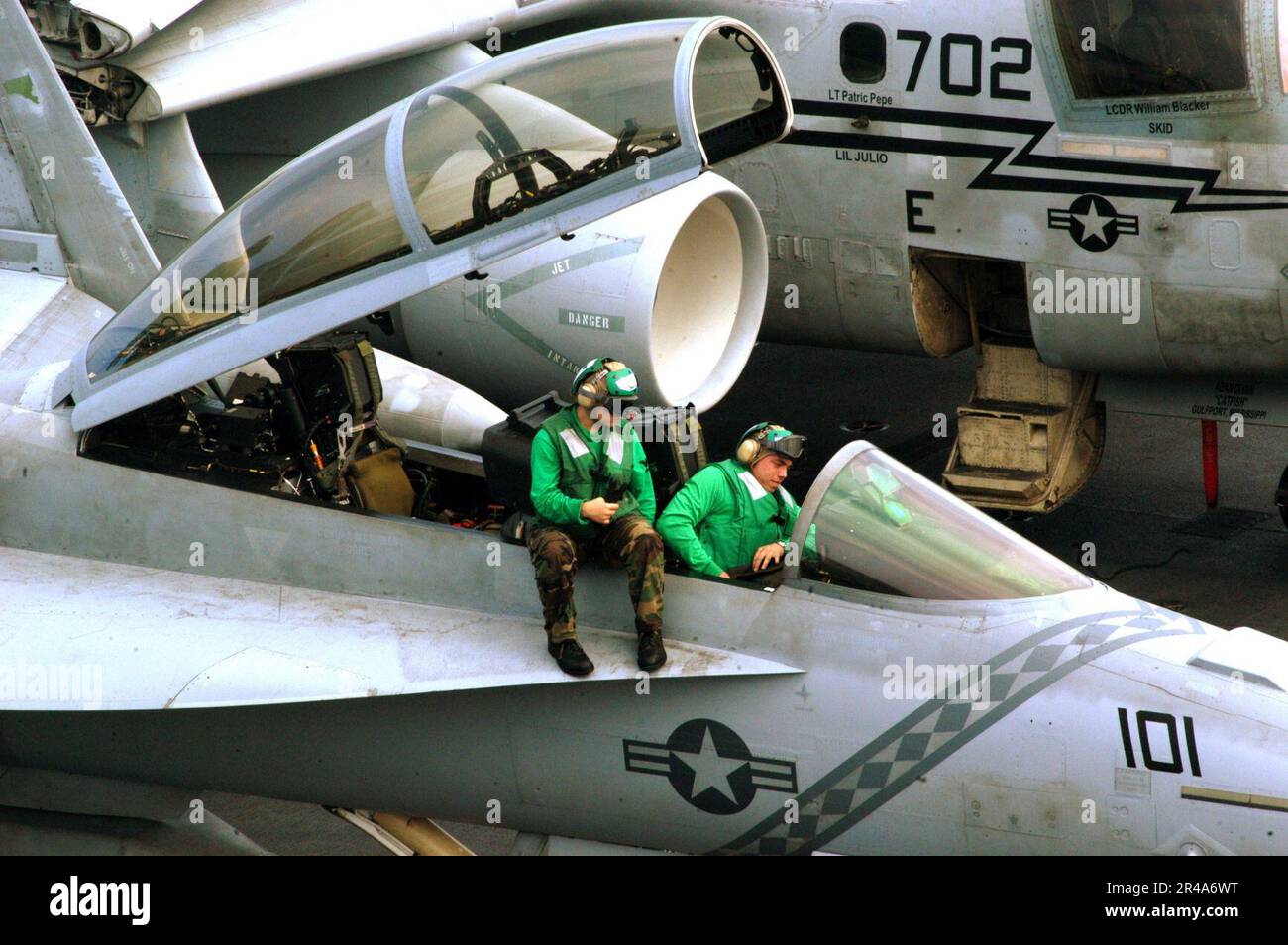 US Navy Aviation Electronics Technicians perform pre-flight checks on ...