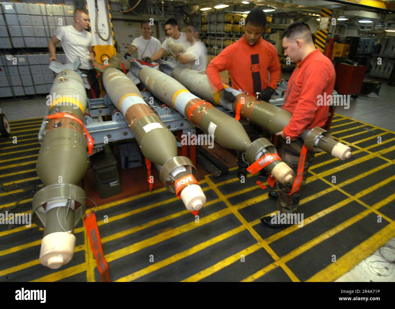 US Navy Members of G-3 bomb assembly division complete the assembly of a MK-82 500lb general-purpose bomb aboard USS John F. Kennedy (CV 67) Stock Photo