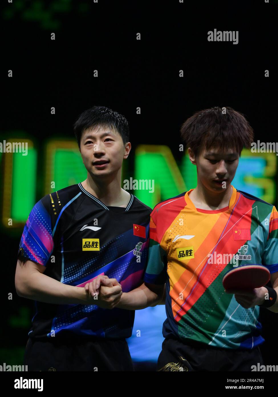Durban, South Africa. 26th May, 2023. Ma Long (L) of China acknowledges