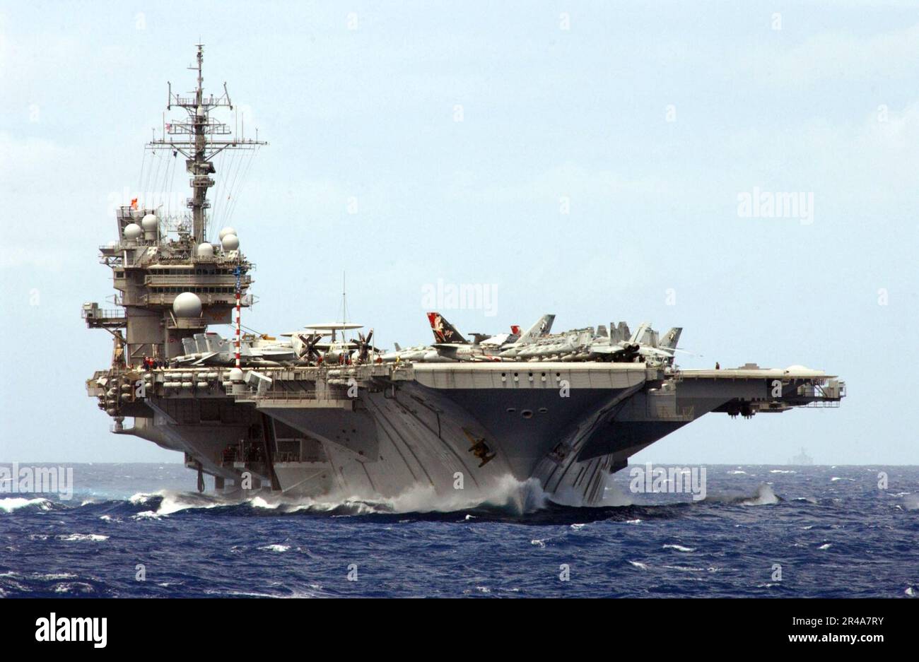 US Navy The aircraft carrier USS Kitty Hawk (CV 63) plows through the waters of the Pacific Ocean as it makes its approach to the Military Sealift Command (MSC) oiler USNS Yukon (T-AO 202) before commencing r Stock Photo