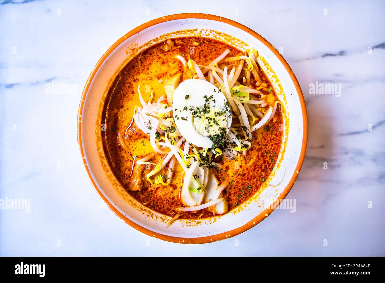 Mee siam is a dish of thin rice vermicelli of hot, sweet and sour flavours, originated in Penang but popular among the Malay and Peranakan communities Stock Photo