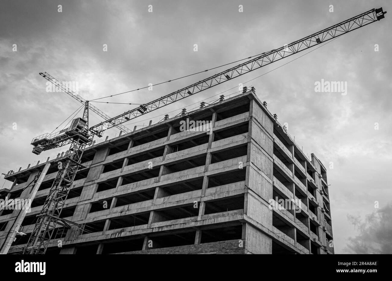 A low angle shot of a tower crane near a residential building Stock ...