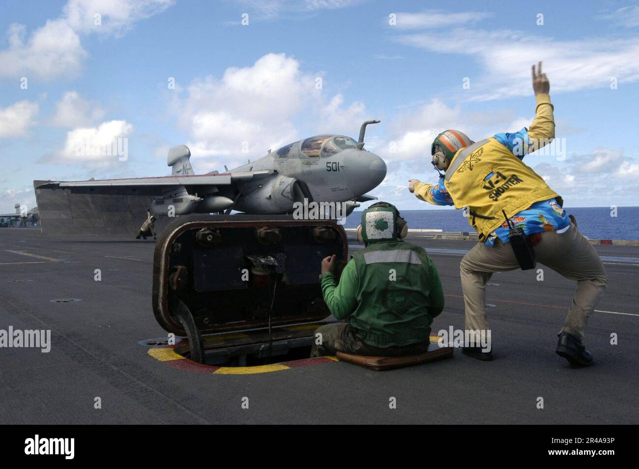 US Navy A catapult shooter from the air department signals to an E-A-6B ...