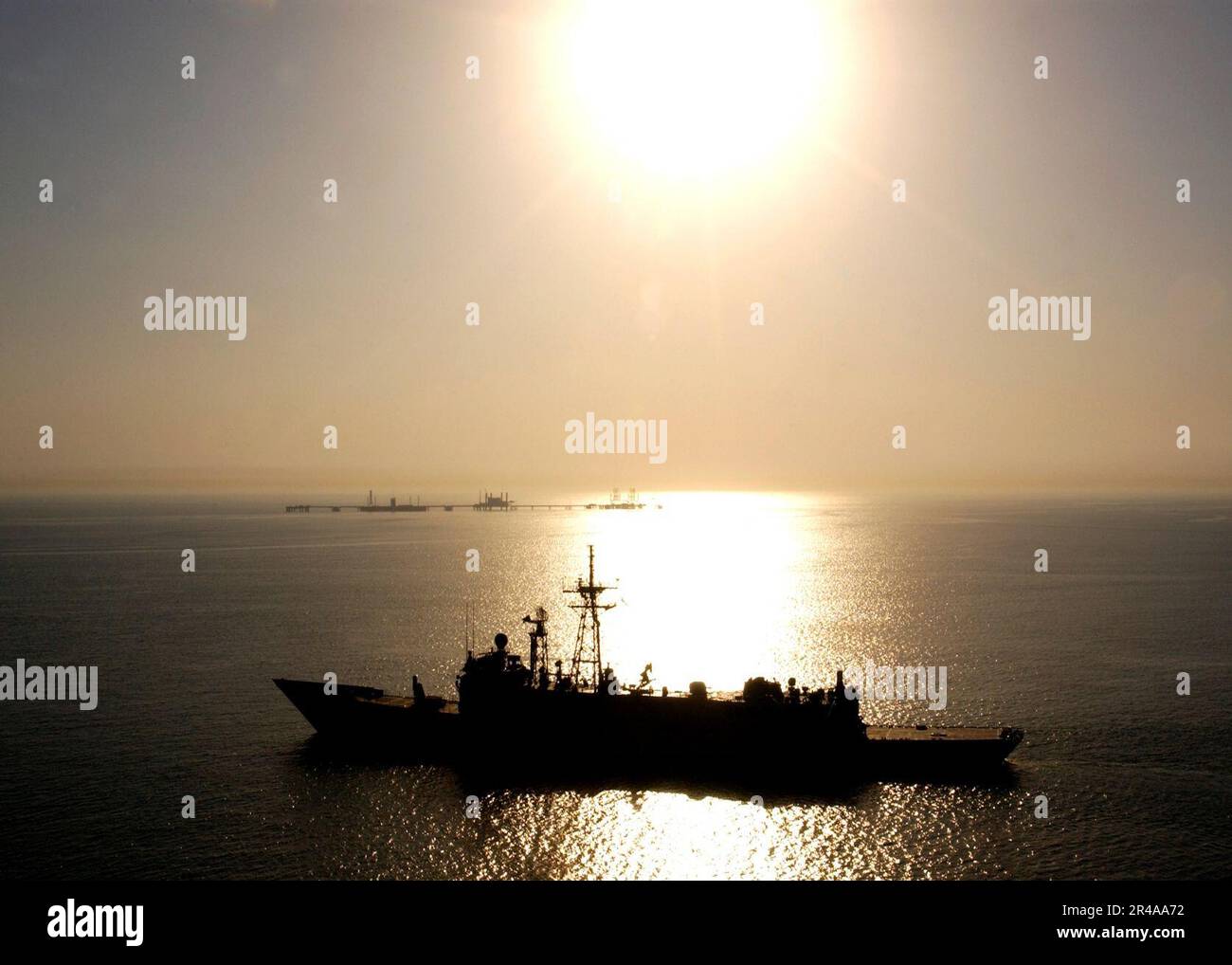 US Navy The Royal Australian Navy guided missile frigate HMAS Adelaide (F01) conducts a patrol near the Khawr AL Amaya Oil Terminal (KAAOT) during joint operations with Coalition forces Stock Photo