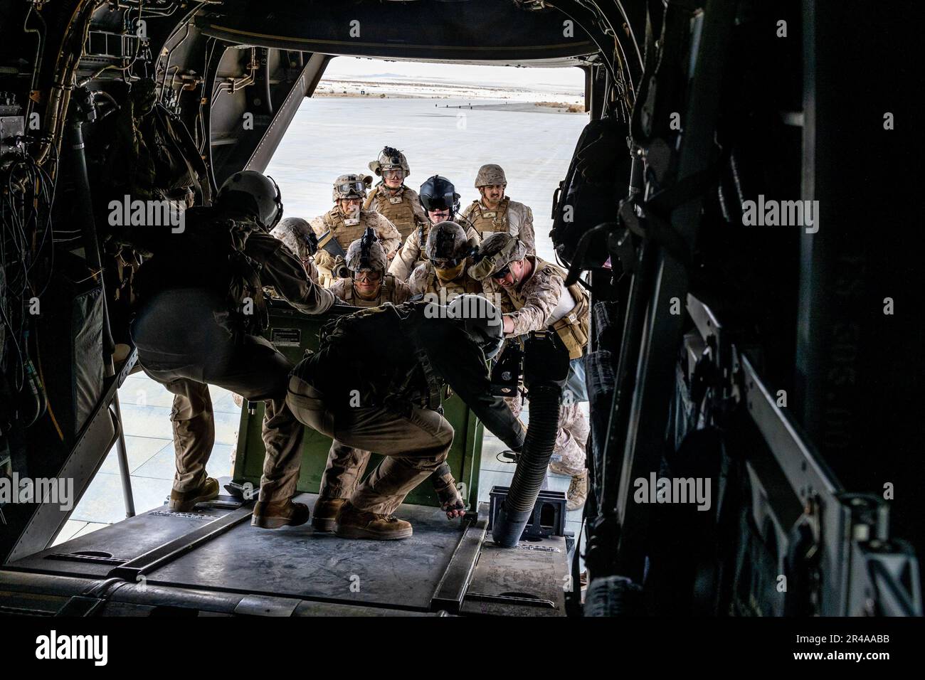 U.S. Marines with Marine Medium Tiltrotor Squadron (VMM) 261 and Marine Wing Support Squadron (MWSS) 272 load a container onto an MV-22B Osprey at Marine Corps Air Ground Combat Center Twentynine Palms, California, Jan. 30, 2023. VMM-261 trained to support Marine ground units during Service Level Training Exercise 2-23, a series of exercises designed to prepare Marines for operations around the globe. VMM-261 and MWSS-272 are subordinate units of 2nd Marine Aircraft Wing, the aviation combat element of II Marine Expeditionary Force. Stock Photo