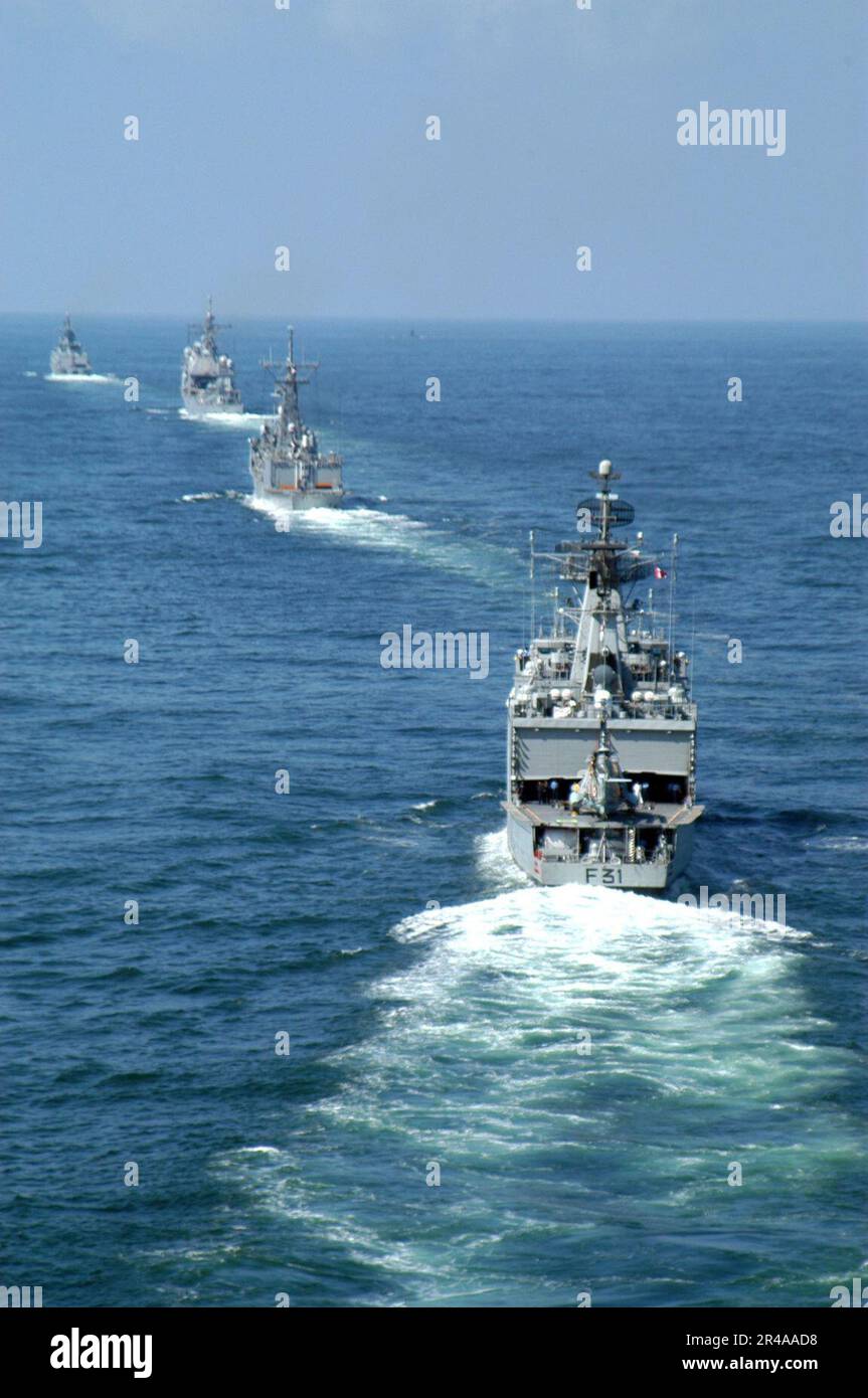 US Navy The Indian Navy frigate INS Brahmaputhra (F 31) follows the guided missile frigate USS Gary (FFG 51) during the opening day of exercise Malabar 04 off the coast of India Stock Photo