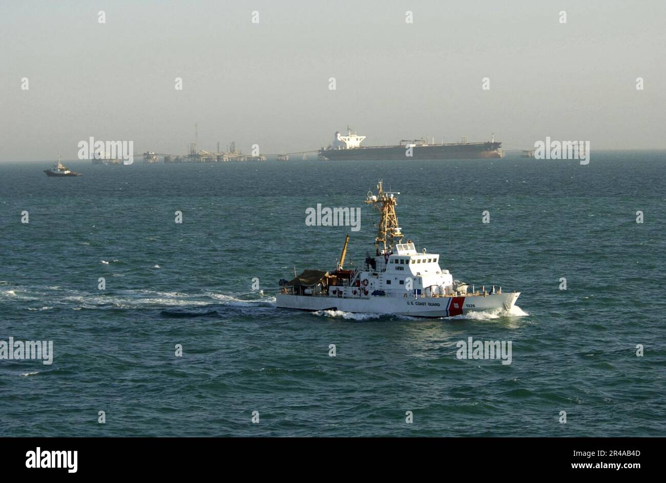 US Navy The U.S. Coast Guard cutter Monomoy (WPB 1326) patrols the waters surrounding the Al Basrah Oil Terminal (ABOT) as a super tanker takes-on crude oil Stock Photo