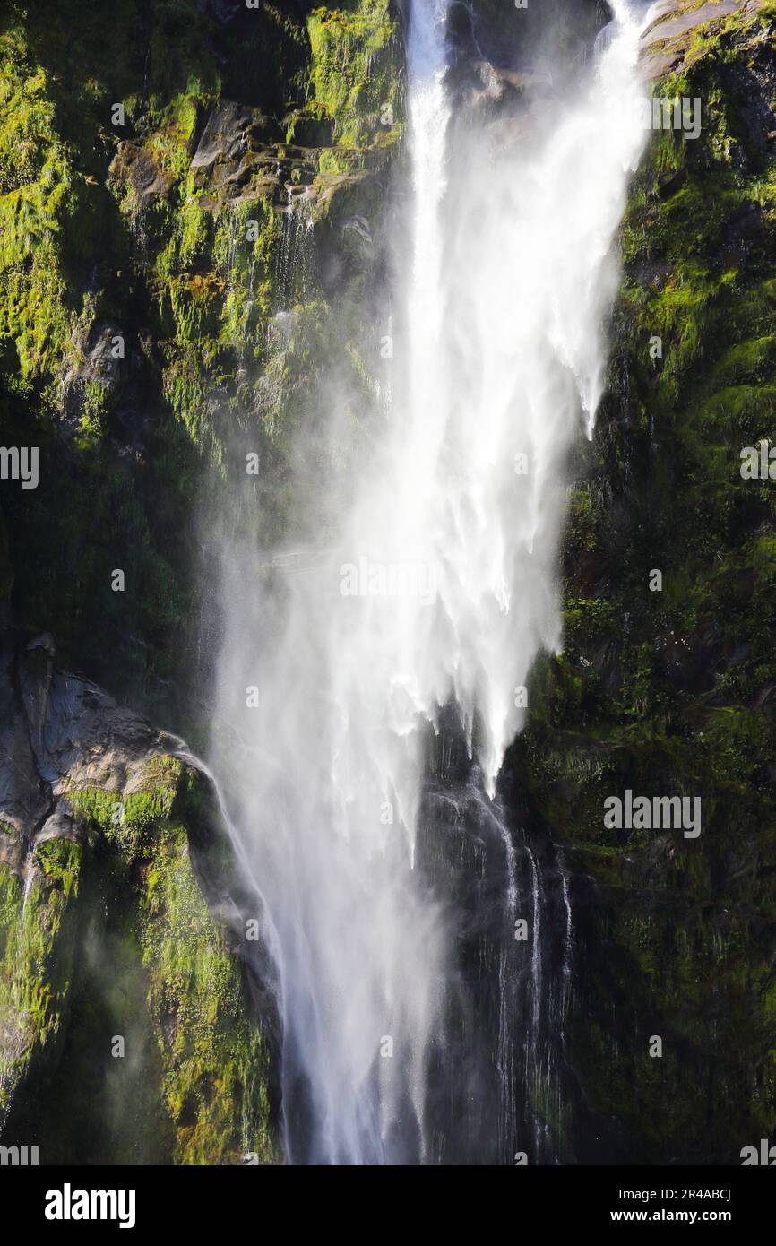 Cascading Cliffs A stunning view of a waterfall cascading down a mountain cliff in ...