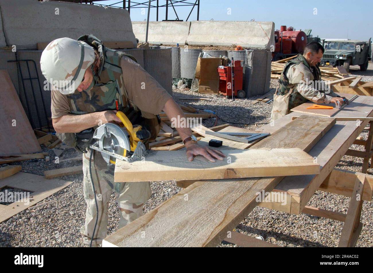 US Navy Construction Electrician 2nd Class and Builder 1st Class both assigned to Naval Mobile Construction Battalion Two Three (NMCB-23), begin construction of stairs for a Sou Stock Photo