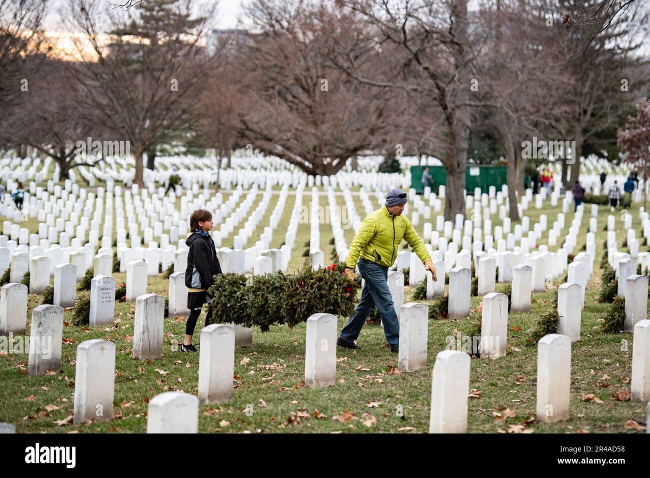 Volunteers participate in the Wreaths Across America’s cleanup day, commonly known as Wreaths