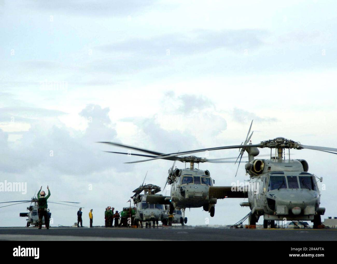 US Navy Helicopters from Helicopter Anti-Submarine Squadron Two (HS-2) Golden Falcons and Helicopter Anti-Submarine Light Squadron Four Seven (HSL-47) Saberhawks depart USS Abraham Lincoln (CVN 72) en route t Stock Photo