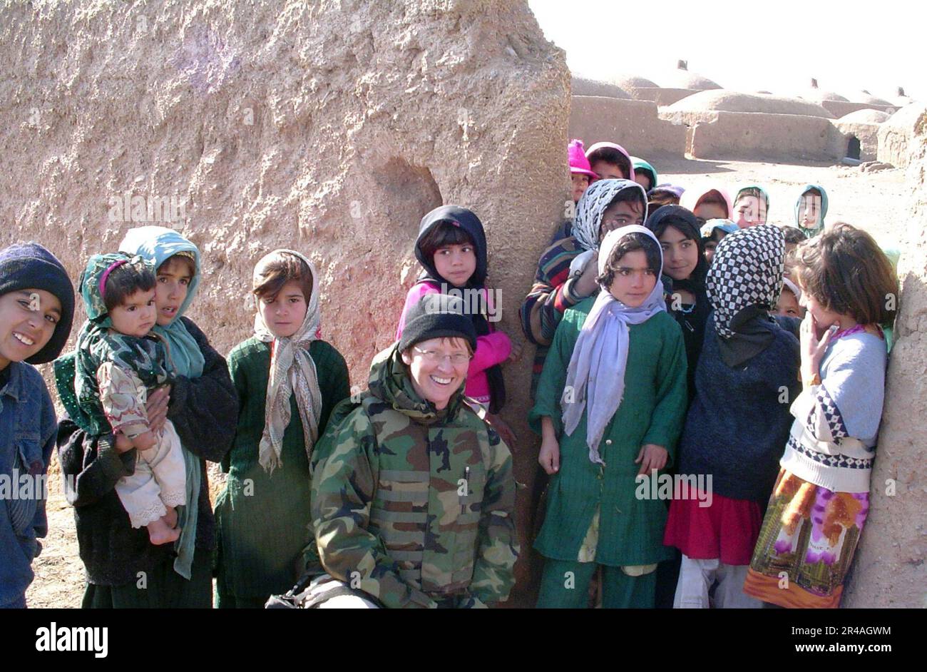 US Navy Cmdr. Kim Evans stops to take a photo with children from the Ghoryan District. Evans is the first female commanding officer of a Provincial Reconstruction Team in Afghanistan Stock Photo
