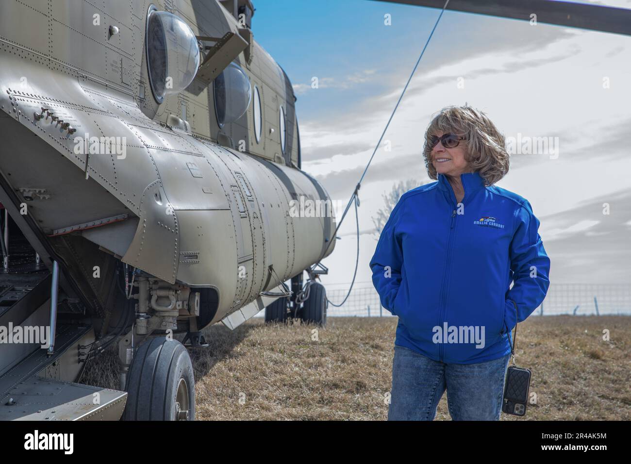 Karen Seaberg, the president of the Atchison Amelia Earhart Foundation,  stands beside a CH-47 Chinook helicopter assigned to the 1st Combat  Aviation Brigade, 1st Infantry Division, in Atchison, Kansas, March 7, 2023.