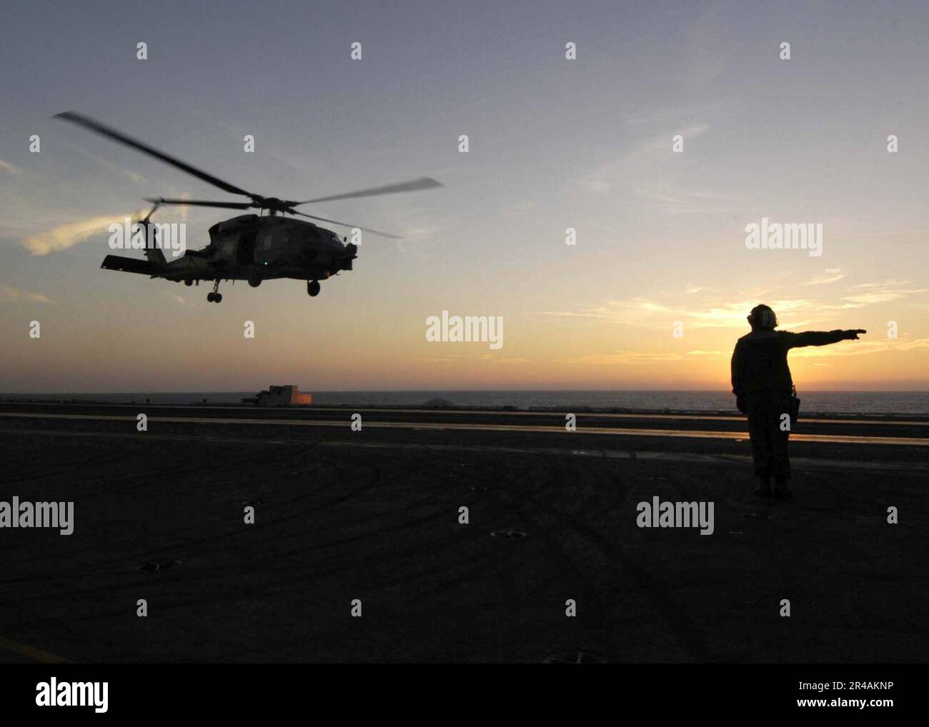 US Navy A Landing Signalman Enlisted signals that an SH60B Seahawk